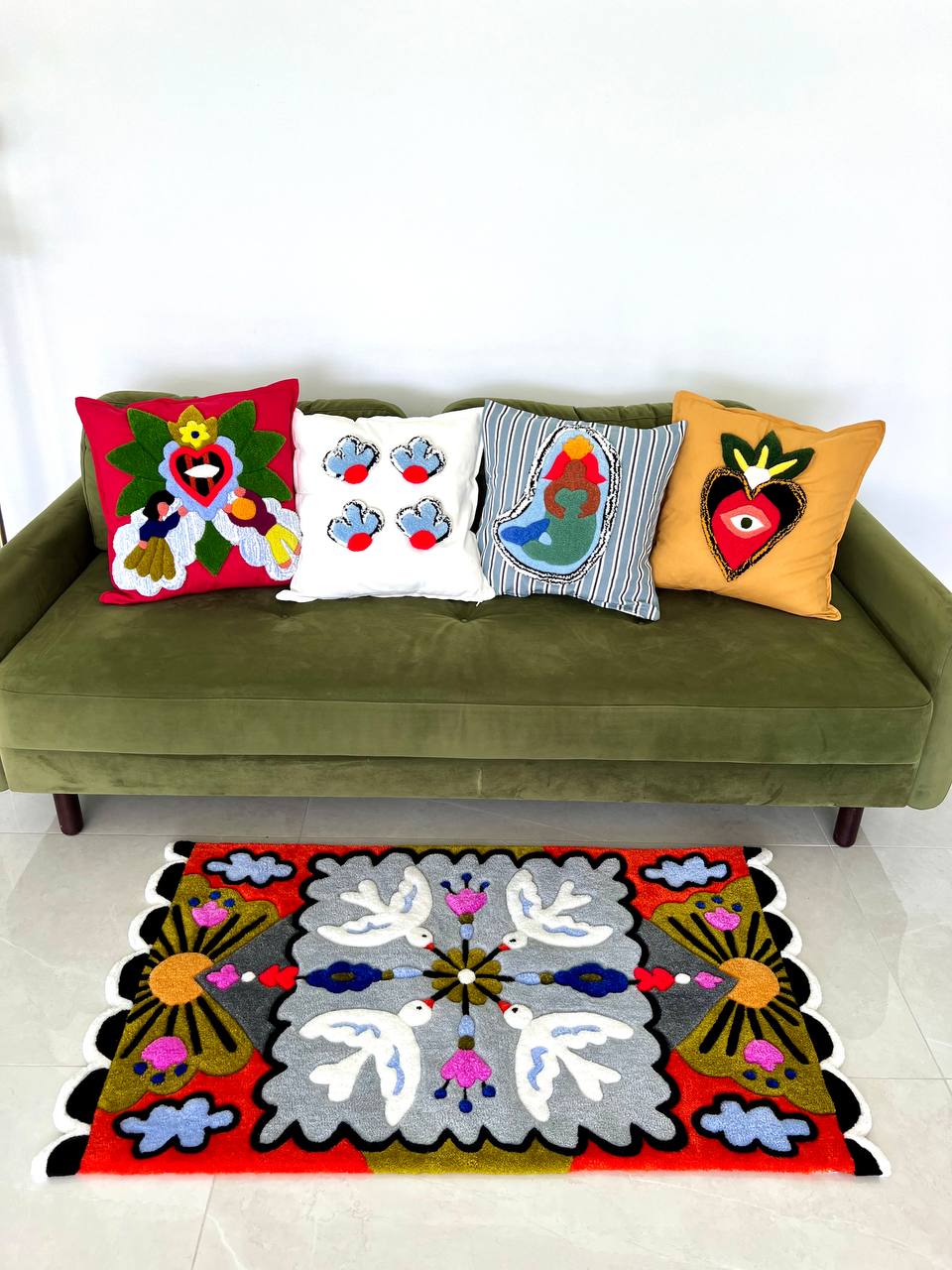 Rugs and pillows on green sofa